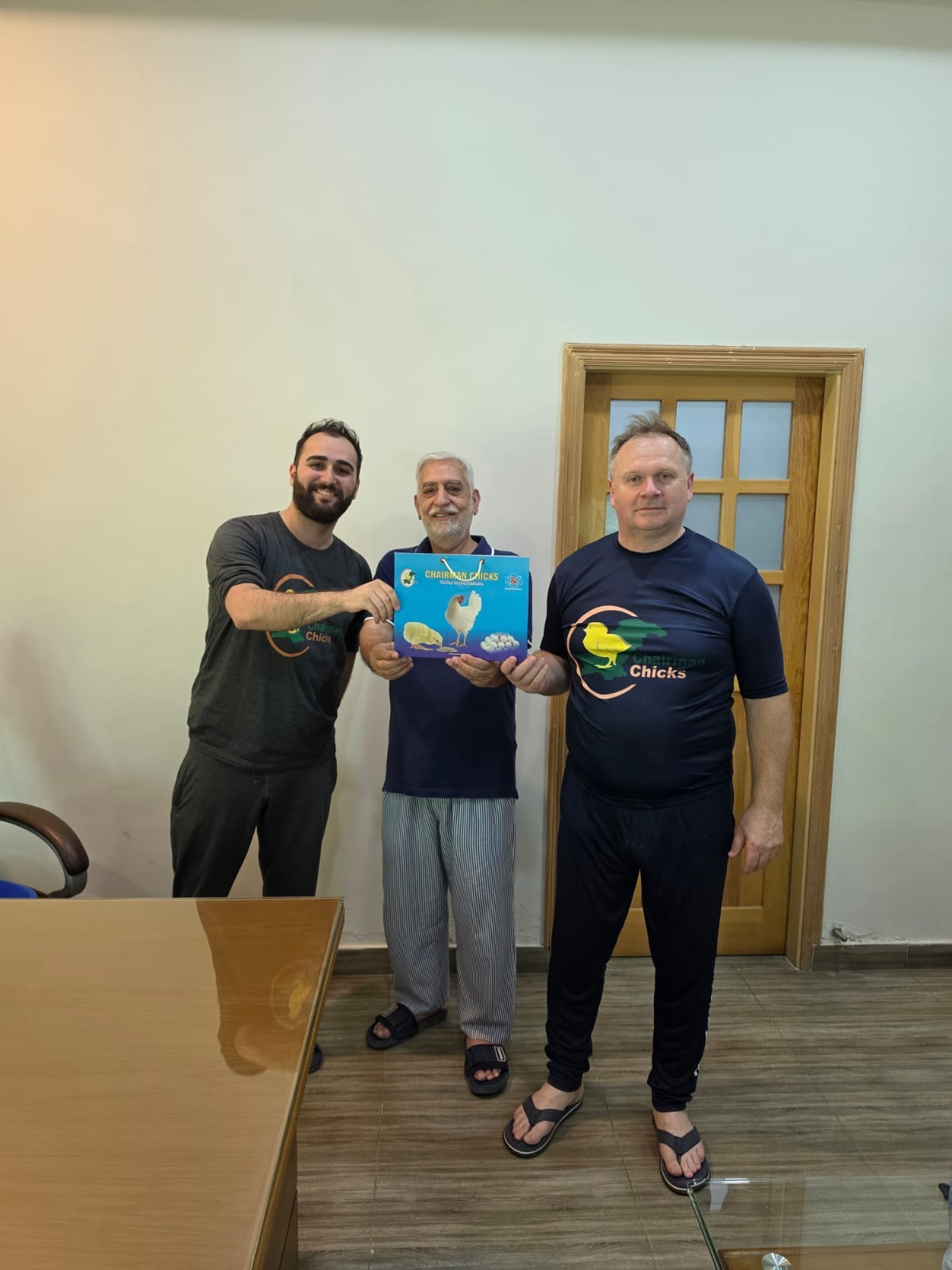 H&N International representative presenting a Chairman Chicks gift box during the hatchery visit